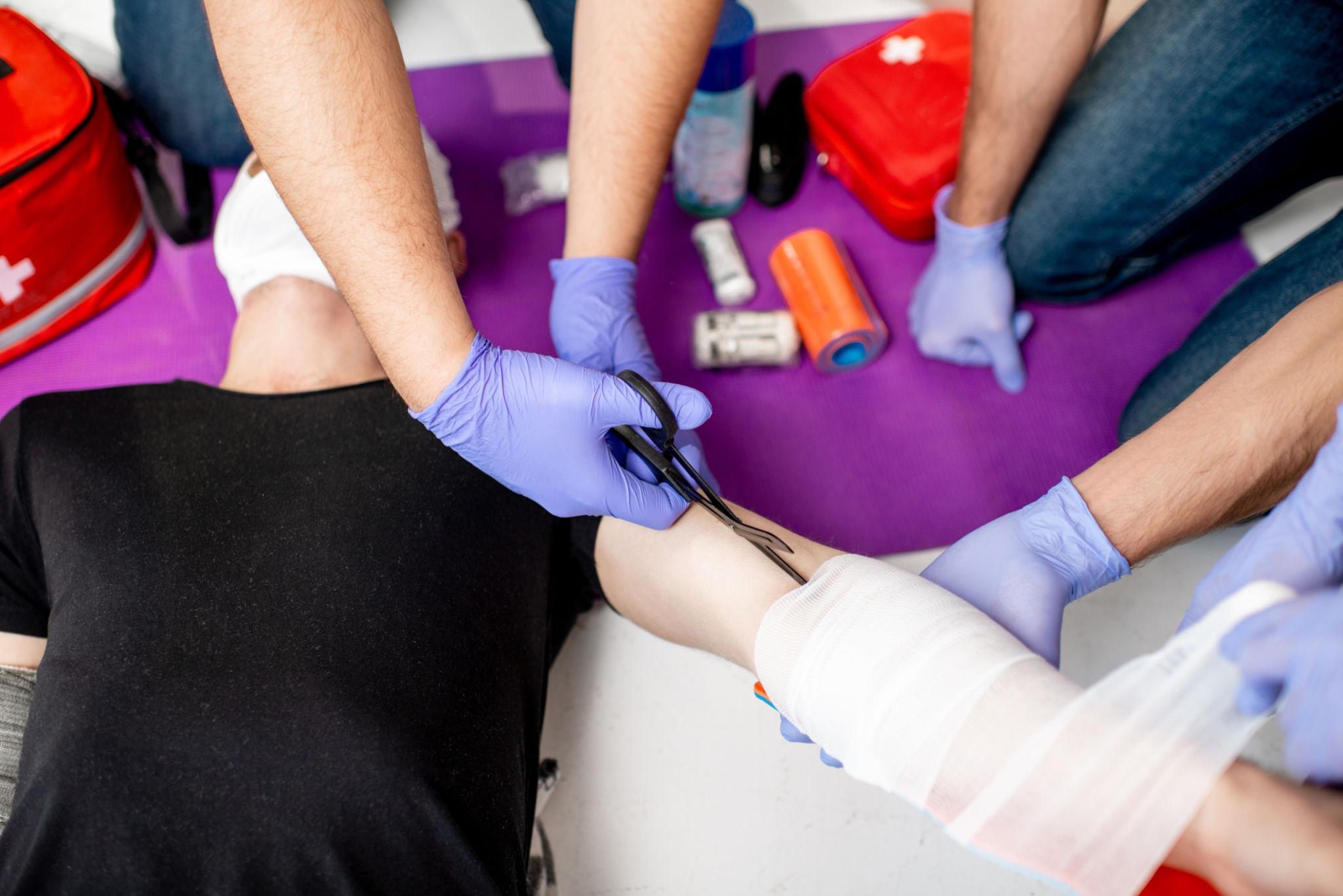Participants developing practical workplace first aid skills during a First Aid at Work training course.