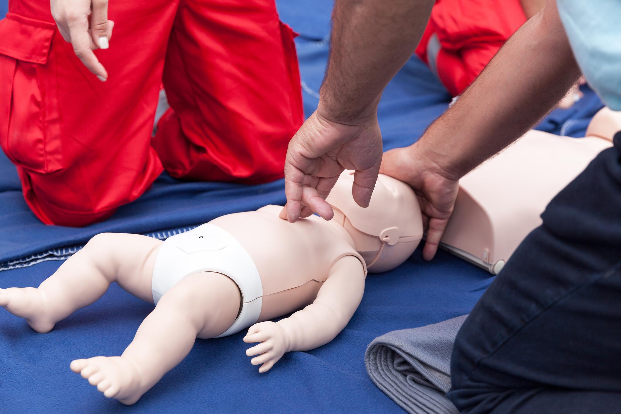 Participants learning life-saving first aid techniques for infants and children during a Paediatric First Aid course.